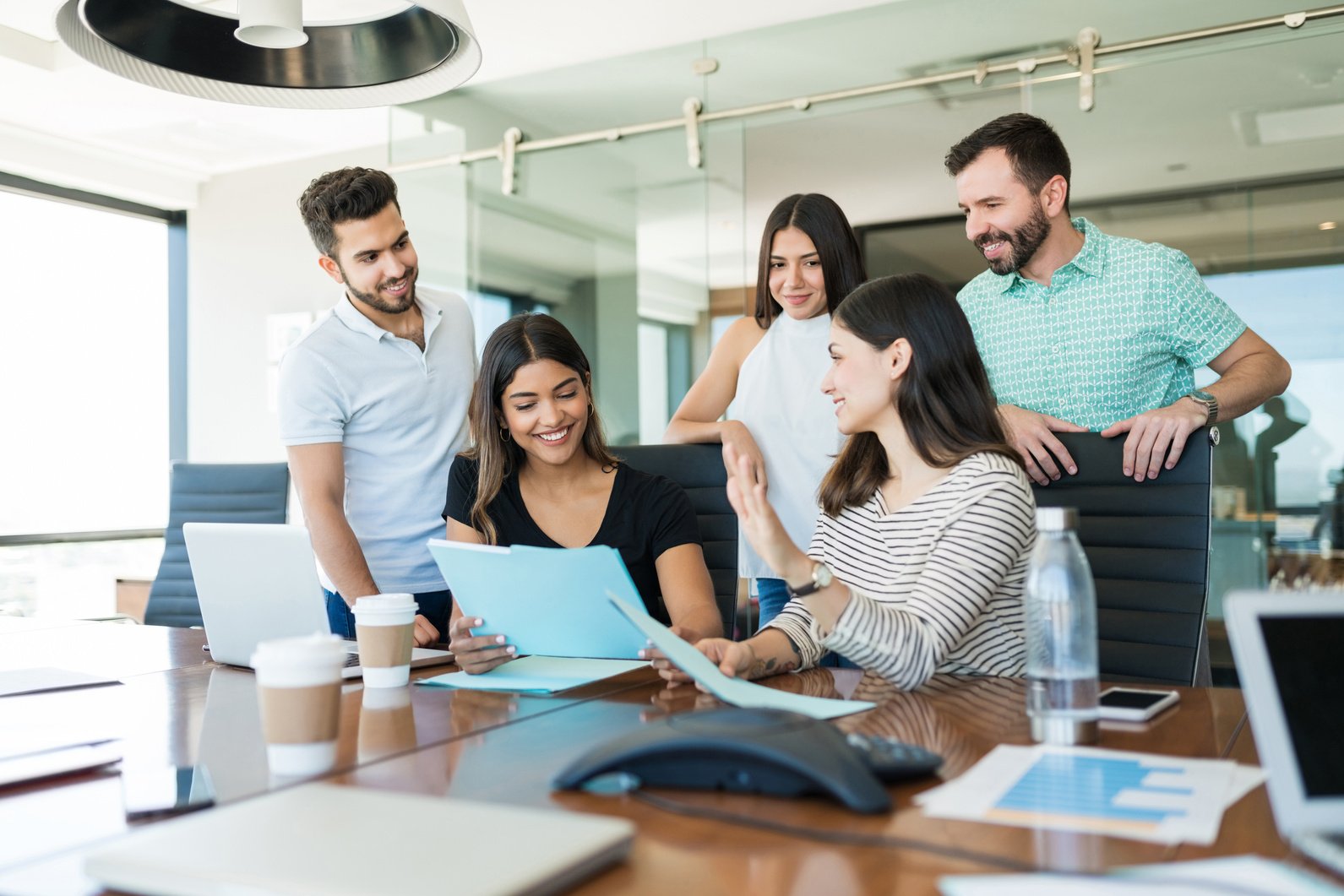 Latin Coworkers In Meeting At Workplace